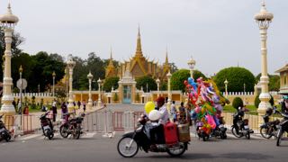 balloon vendor rides in front of the royal palace. phnom penh.