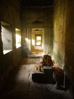 shadows on a headless buddha. ta prohm, angkor.